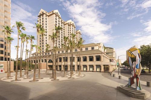 a rendering of a building with palm trees and a statue at Signia by Hilton San Jose in San Jose