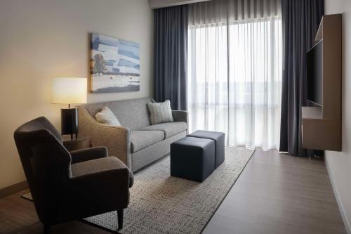 a living room with a couch and a chair at Embassy Suites By Hilton Bowling Green in Bowling Green