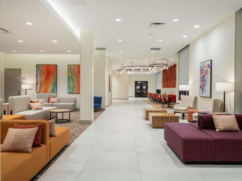 a lobby of a hospital with couches and tables at Hilton Garden Inn Jeffersonville, In in Jeffersonville