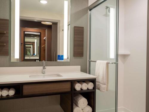 a bathroom with a sink and a shower at Hilton Garden Inn Jeffersonville, In in Jeffersonville