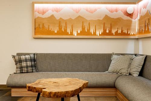 a living room with a couch with a wooden coffee table at Ku Dolinie in Kościelisko