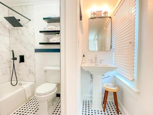 a white bathroom with a sink and a toilet at Beachliner Hotel in Ocean Grove