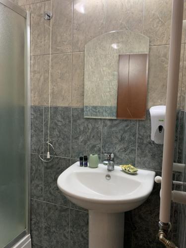 a bathroom with a sink and a mirror at Royal L Hotel in Carev Dvor