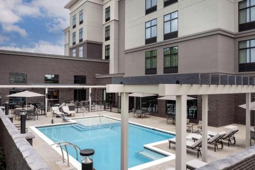 a swimming pool in front of a building at Homewood Suites By Hilton Louisville Airport in Louisville