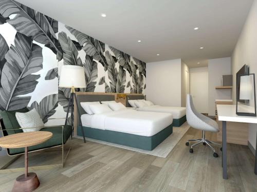 a bedroom with a bed and a desk and chair at Hilton Garden Inn St Augustine-Historic District in Saint Augustine