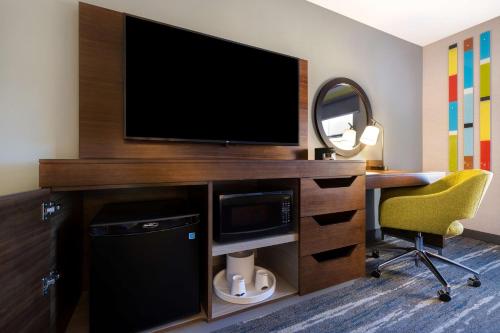 a room with a desk with a television and a chair at Hampton Inn & Suites Marina in Marina
