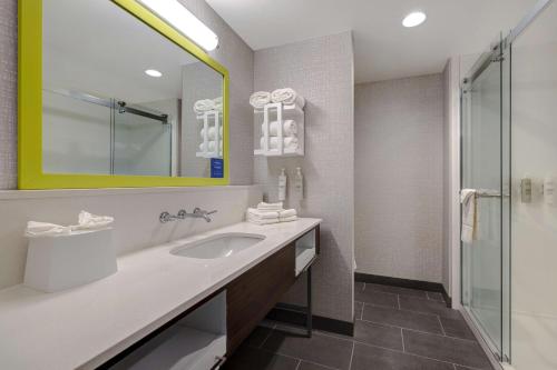 a bathroom with a sink and a mirror at Hampton Inn & Suites Marina in Marina