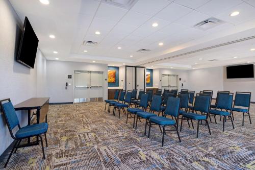 a conference room with chairs and a table and a screen at Hampton Inn & Suites Marina in Marina