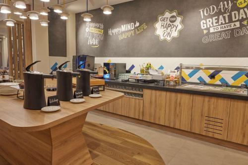 a fast food restaurant with a counter with a food counter at Hampton By Hilton Poznan Swarzedz in Swarzędz