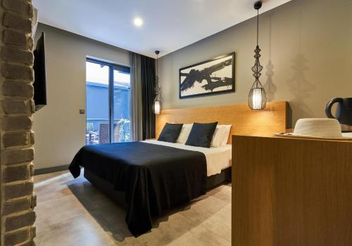 a bedroom with a bed and a large window at Loft 1502 in Antalya