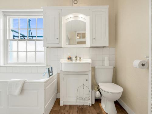 a white bathroom with a sink and a toilet at Pass the Keys A Period Building in the Heart of Canterbury in Canterbury