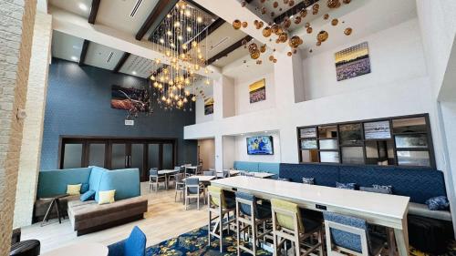 a dining room with a bar and chairs at Hampton Inn & Suites Weatherford, Tx in Weatherford