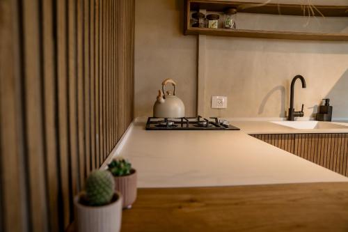 a kitchen with a tea kettle on a stove at Dawar Sinai Bliss - Luxury Haven in Ma'ale Adumim