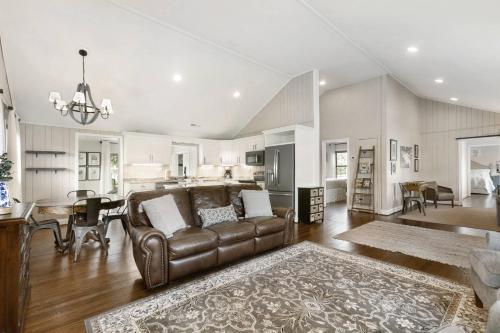 a large living room with a couch and a table at Mill Stream Cottage in Pigeon Forge
