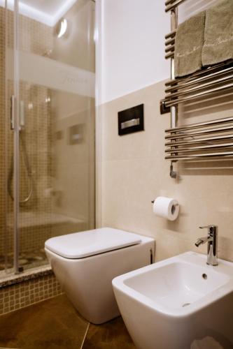 a bathroom with a toilet and a sink and a shower at Faro di Punta Fenaio in Campese