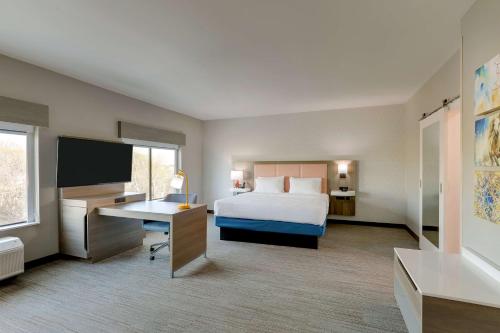 a hotel room with a bed and a desk and a television at Hampton Inn & Suites Weatherford, Tx in Weatherford