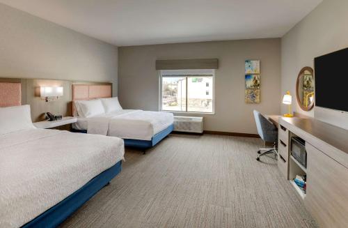 a hotel room with two beds and a desk at Hampton Inn & Suites Weatherford, Tx in Weatherford