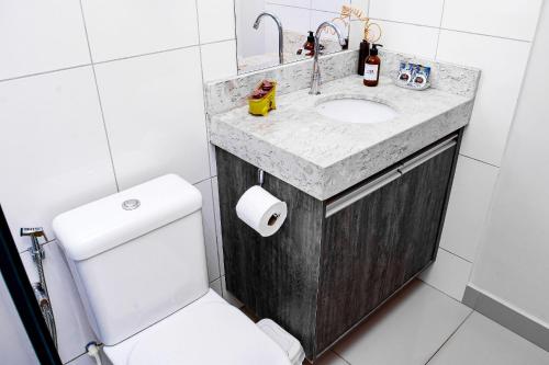 a bathroom with a sink and a toilet at Acomodação Extraordinária em sua viagem - LoftFelau in Cuiabá
