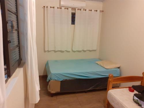 a small room with a bed and a window at Chácara com Piscina in Araçoiaba da Serra