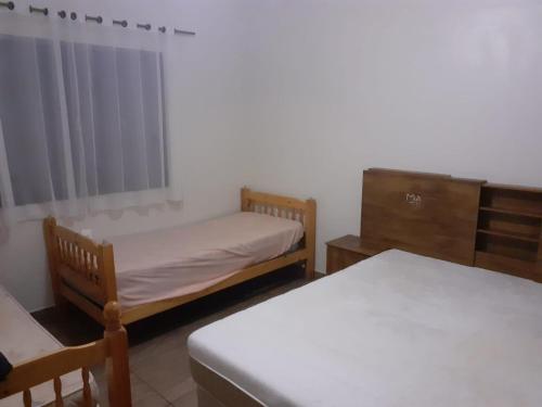 A bed or beds in a room at Chácara com Piscina