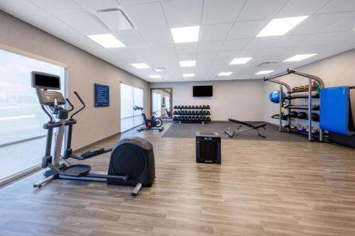 a gym with a treadmill and a chair in a room at Hampton Inn Kansas City Southeast, Mo in Kansas City