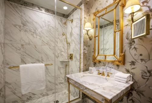 a bathroom with a sink and a mirror at Waldorf Astoria Washington DC in Washington