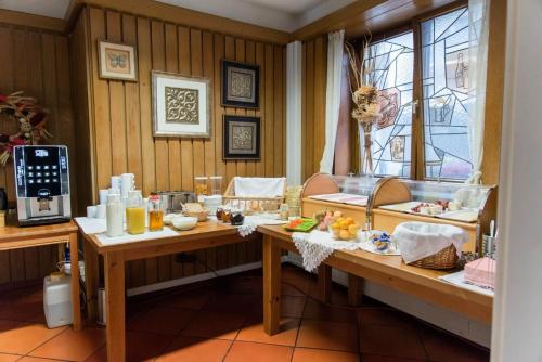 a room with two tables with food on it at Hotel Garni Ratstube in Bad Urach