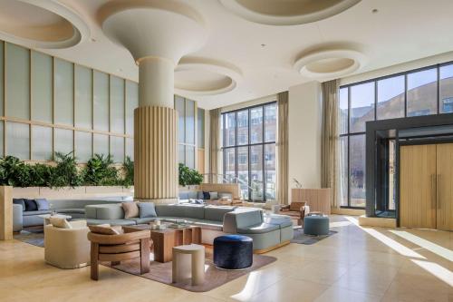a lobby with a couch and tables and windows at The Morrow Washington Dc, Curio Collection By Hilton in Washington