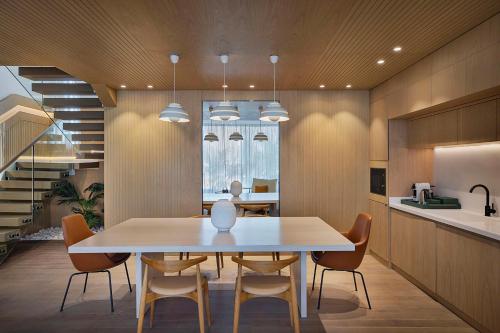 a kitchen and dining room with a table and chairs at Katara Hills Doha, Lxr Hotels & Resorts in Doha