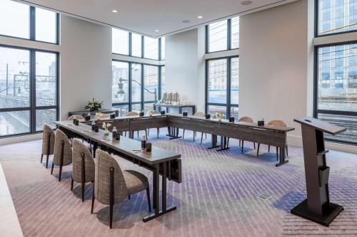 a conference room with tables and chairs and windows at The Morrow Washington Dc, Curio Collection By Hilton in Washington