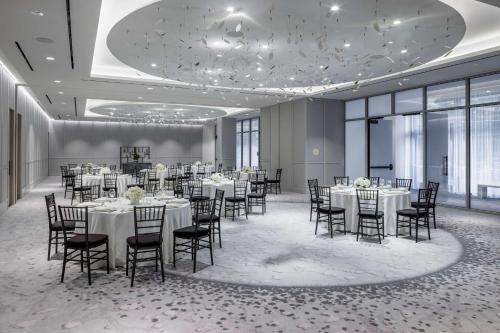 a banquet hall with tables and chairs in a room with windows at The Morrow Washington Dc, Curio Collection By Hilton in Washington