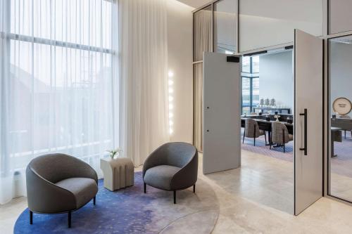 a lobby with two chairs and a table in a room at The Morrow Washington Dc, Curio Collection By Hilton in Washington