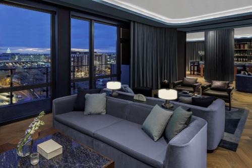 a living room with a couch and large windows at The Morrow Washington Dc, Curio Collection By Hilton in Washington