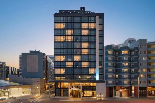 a tall building with many windows in a city at Canopy by Hilton San Francisco SoMa in San Francisco