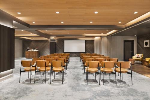 a conference room with chairs and a projection screen at Canopy by Hilton San Francisco SoMa in San Francisco