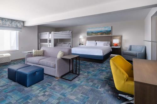 a hotel room with a bed and a couch and chair at Hampton Inn & Suites Salida, CO in Salida