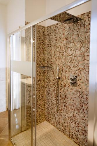 a bathroom with a shower with a glass door at Faro di Punta Fenaio in Campese