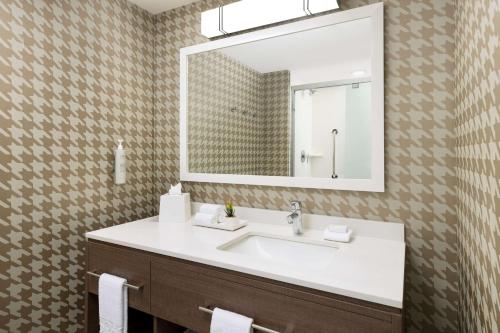 a bathroom with a white sink and a mirror at Home2 Suites By Hilton North Scottsdale Near Mayo Clinic in Scottsdale