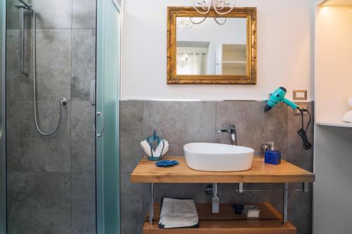 a bathroom with a sink and a shower at A Ugghia- I Mori in Fiumefreddo di Sicilia