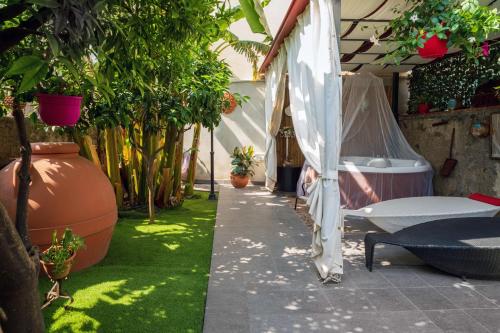 a garden with a bed and some plants at A Ugghia- I Mori in Fiumefreddo di Sicilia