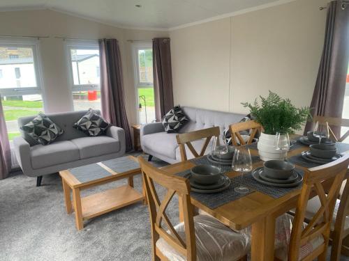 a living room with a table and a couch at 136, Port Haverigg in Millom