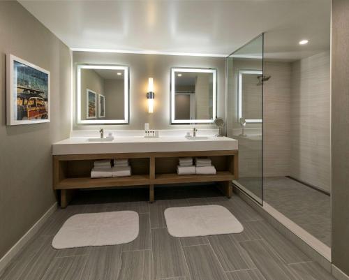a bathroom with a sink and a shower at Inn at the Pier Pismo Beach, Curio Collection by Hilton in Pismo Beach