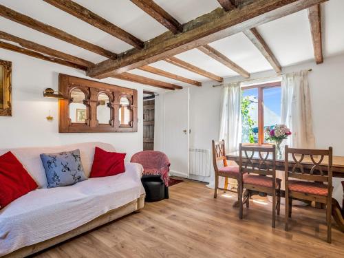 a living room with a couch and a table at Pass the Keys Lovely Cottage just outside of Canterbury in Canterbury