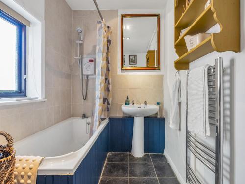 a bathroom with a sink and a bath tub and a sink at Pass the Keys Lovely Cottage just outside of Canterbury in Canterbury