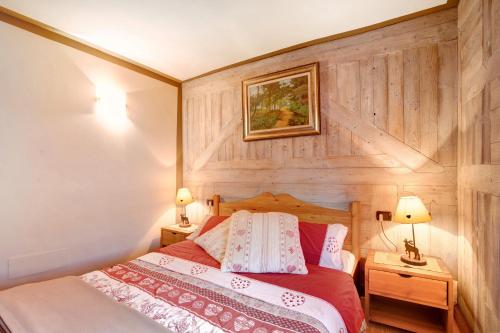 a bedroom with a wooden wall with a bed at Maison Grange 4 in Gressan
