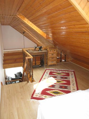 a attic room with a wooden ceiling and a table at Zrínyi ház in Szántód