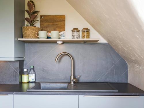 a kitchen with a sink and a counter top at The Loft - A Stylish Holiday Property in Weymouth with Sea View and Parking in Weymouth