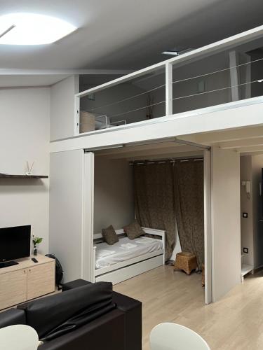 a loft bed in a living room with a bed at B&B Apartamentos Lorione in Olite