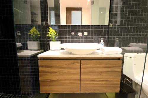 a bathroom with a white sink and a mirror at Spacious Studio, incredible rooftop with sea view in Playa del Carmen