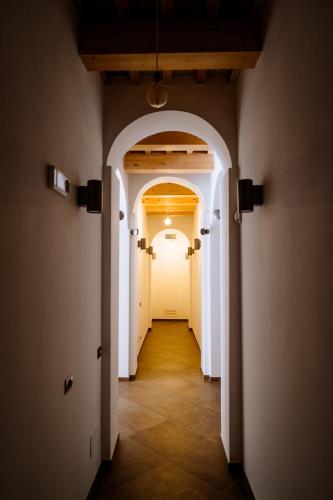 an empty hallway with white doors and a hallwayngth at Faro di Punta Fenaio in Campese